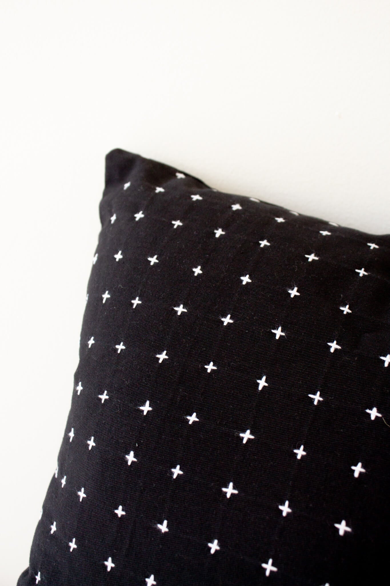 https://www.palmandperkins.com/cdn/shop/products/AnchalProject_MediumCross-StitchThrowPillow_Charcoal-1_2048x.jpg?v=1622245408